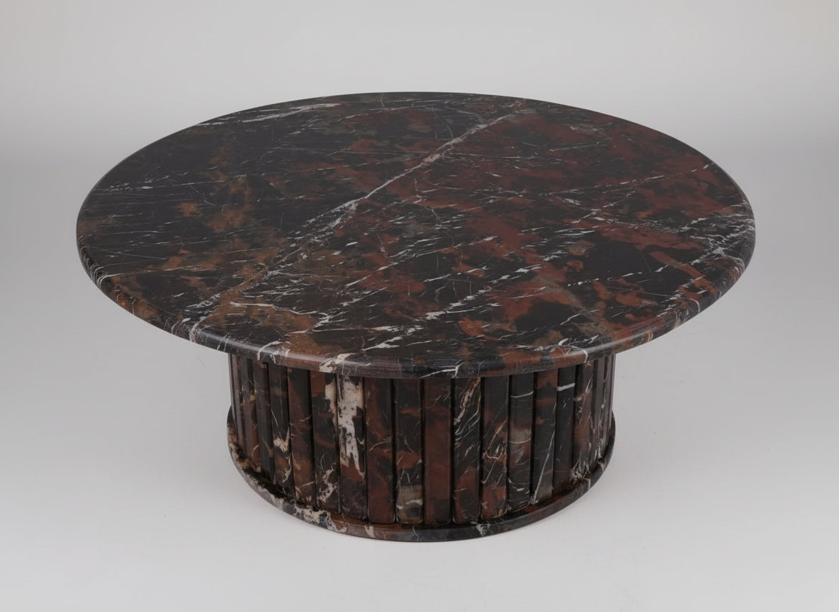 Round marble table with dark brown and black marbled pattern on a white background