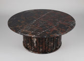 Round marble table with dark brown and black marbled pattern on a white background