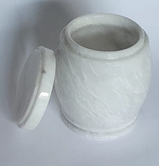 White marble-patterned jar urn with lid on a light gray background