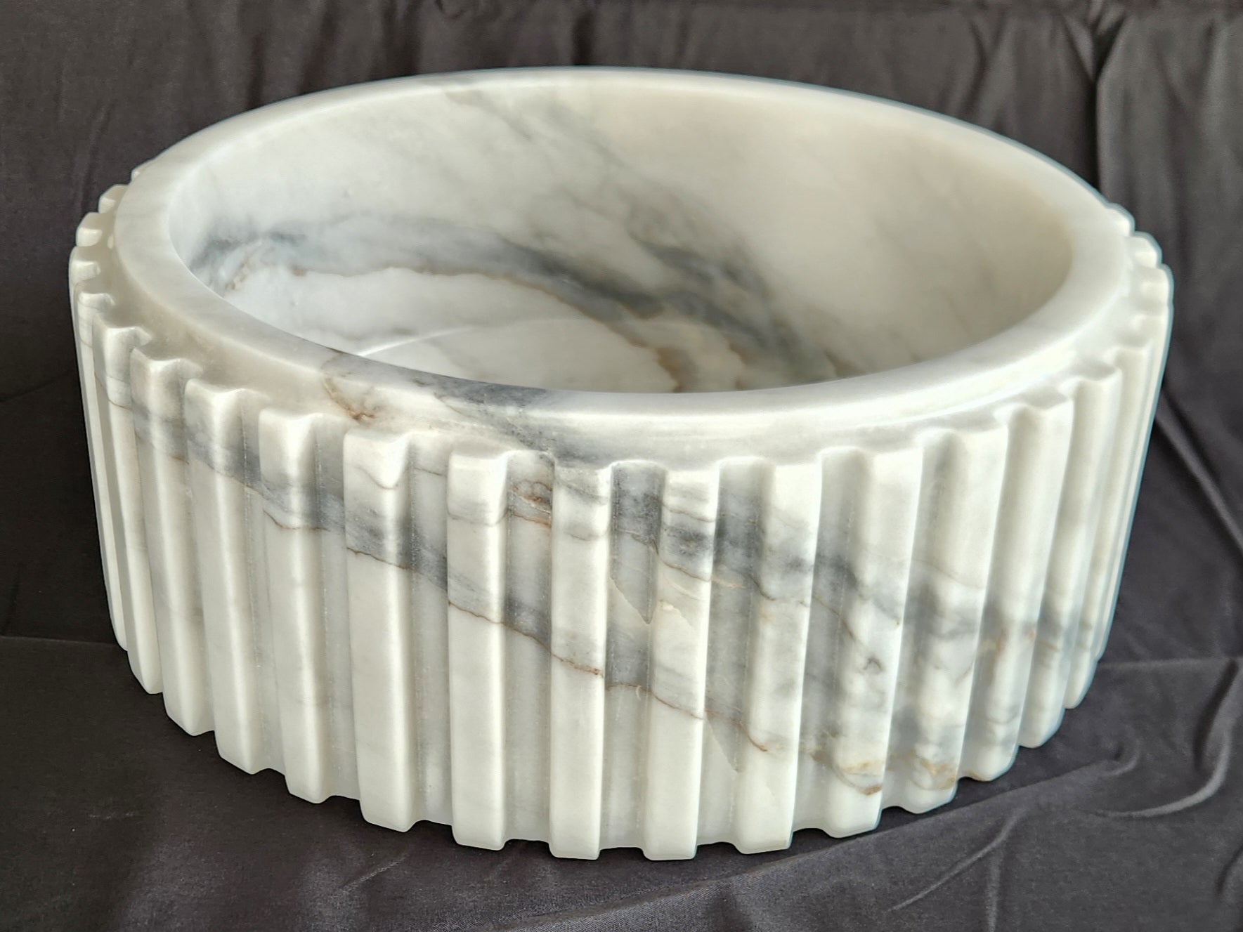 Marble-patterned bowl on a dark fabric background