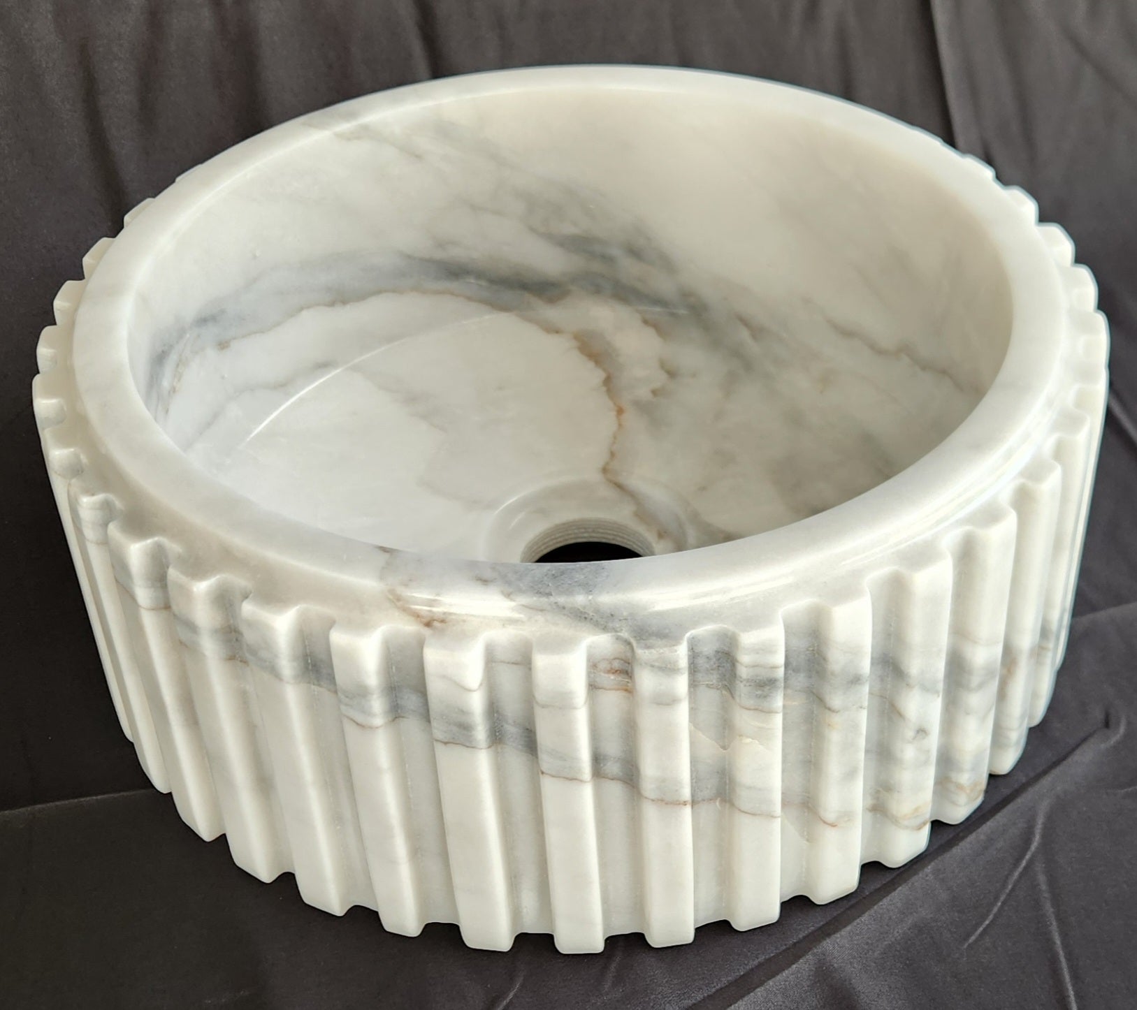 Marble-patterned sink on a dark background