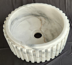 Fluted Marble-patterned sink on a dark background