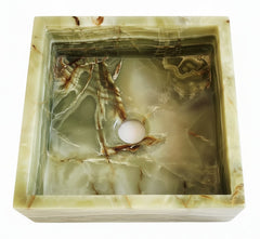 Hexagonal green onyx sink with natural patterns on a white background