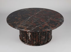 Round marble table with dark brown and black marbled pattern on a white background