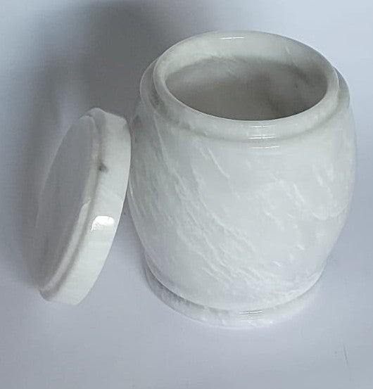 White marble-patterned jar urn with lid on a light gray background