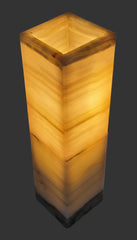 Square-shaped lamp with a warm glow on a plain background
