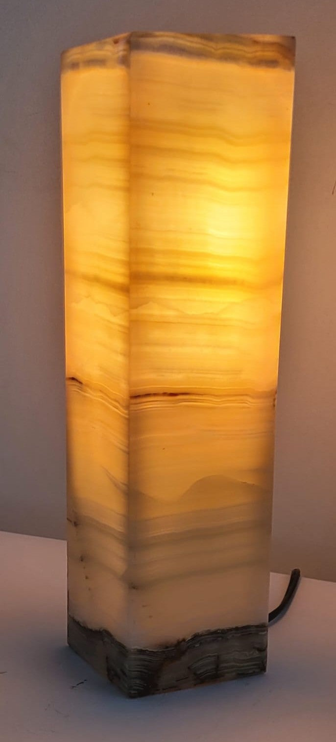 Decorative marble lamp with a textured design on a plain background