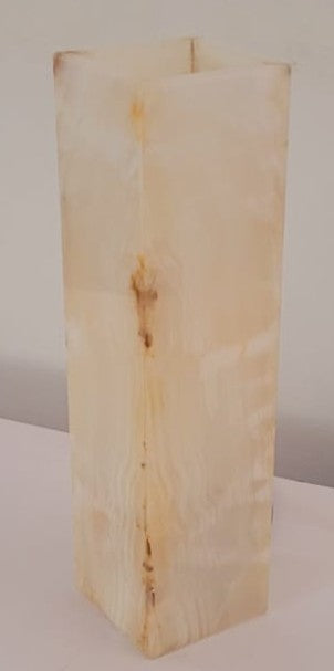 Rectangular wooden block with a light brown color on a white background