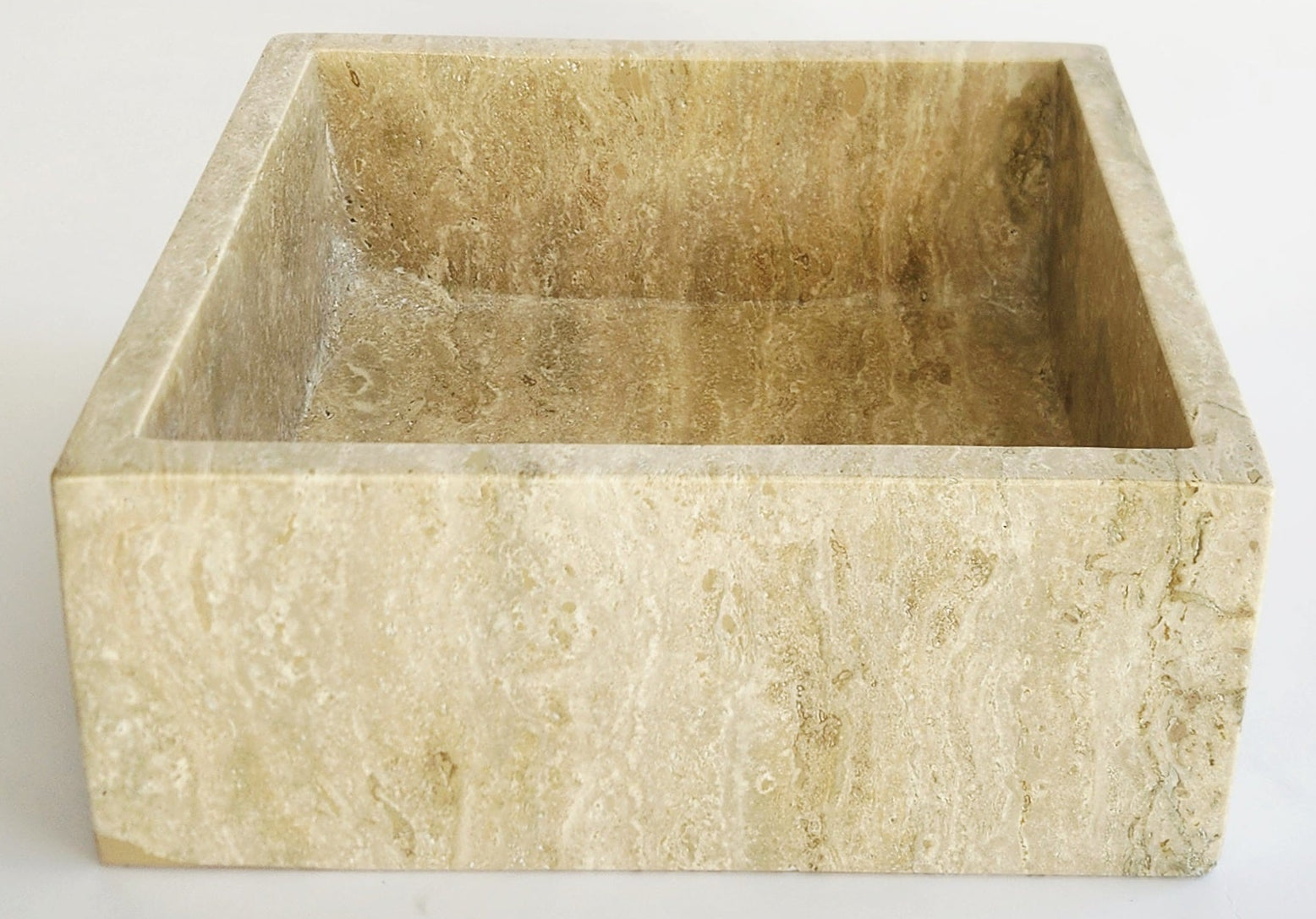 Square beige stone basin on a white background