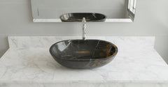 Black marbled oval sink on a white background
