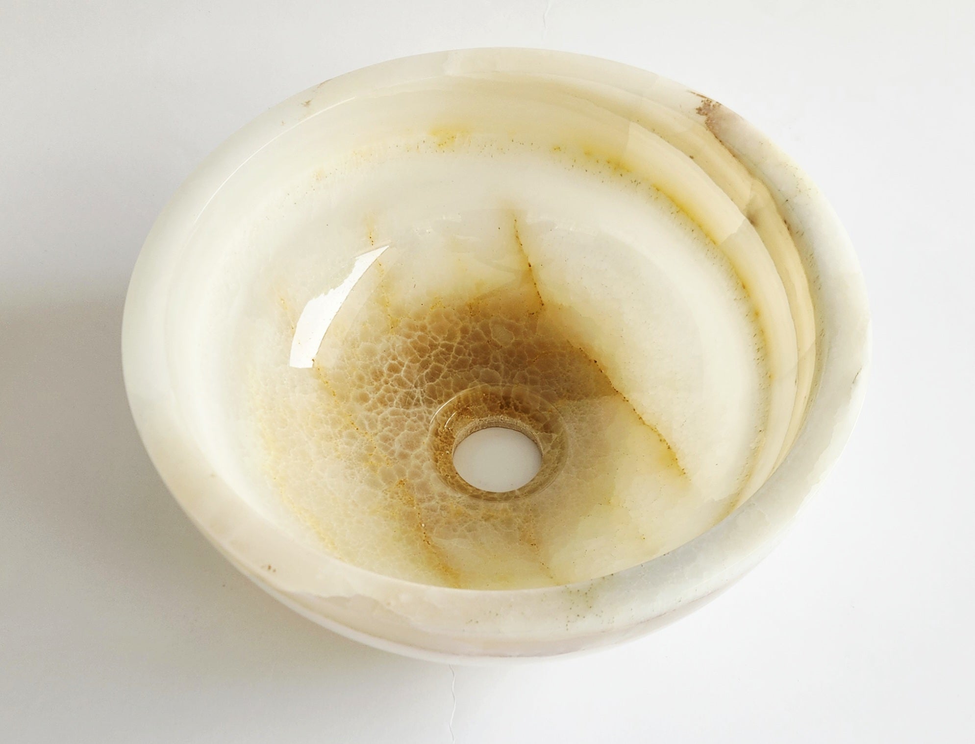 Round stone with concentric circles on a white background